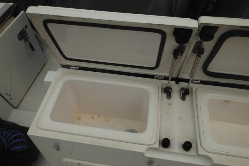 Slide: The Image of Open storage compartments on a 2006 Southport 26 Center Console boat. - 51