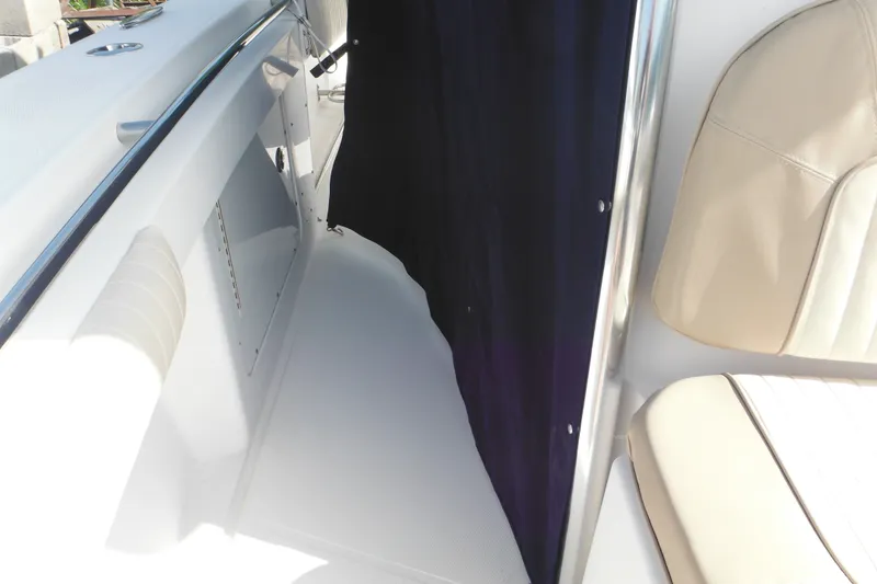 Slide: The Image of Interior view of a 2006 Southport 26 Center Console boat, featuring seating and storage. - 77