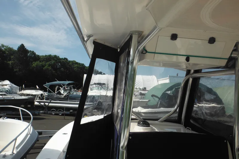 Slide: The Image of 2006 Southport 26 Center Console boat docked at marina under clear sky. - 82