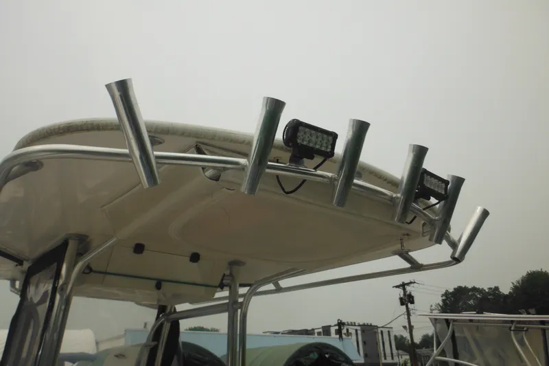 Slide: The Image of 2006 Southport 26 Center Console boat with rod holders and mounted lights on the T-top. - 55