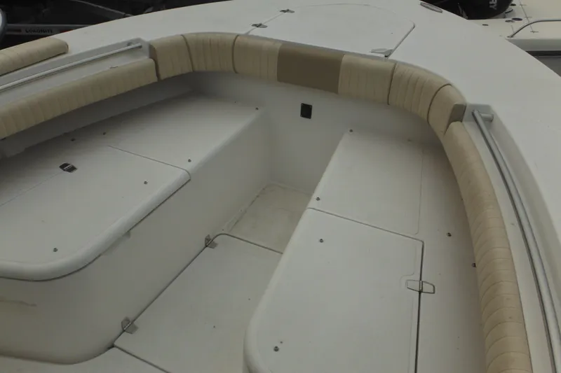 Slide: The Image of 2006 Southport 26 Center Console boat interior with cushioned seating and storage compartments. - 61