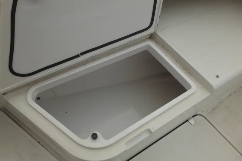 Slide: The Image of Storage compartment on a 2006 Southport 26 Center Console boat, open and empty. - 62