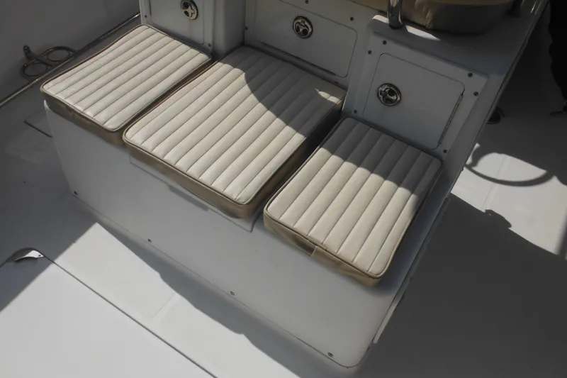 Slide: The Image of Three cushioned seats on a 2006 Southport 26 Center Console boat. - 79