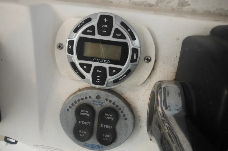 Slide: The Image of Kenwood audio controls on 2006 Southport 26 Center Console boat dashboard. - 43