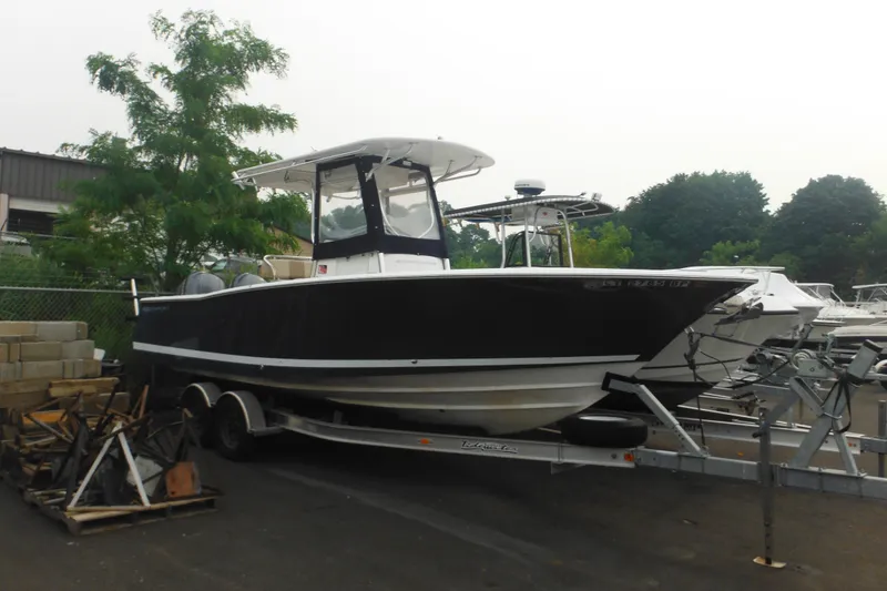 The Image of 2006 Southport 26 Center Console boat on trailer, parked outdoors. - 0