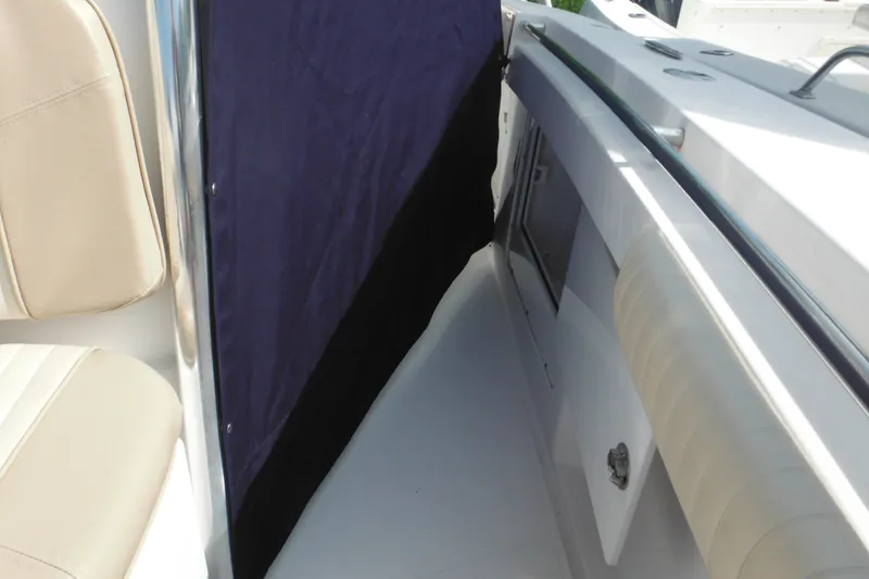 Slide: The Image of Interior view of a 2006 Southport 26 Center Console boat, featuring seating and storage. - 76