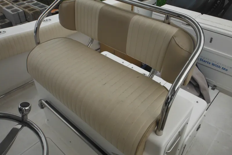 Slide: The Image of 2006 Southport 26 Center Console boat seat with chrome railings and beige upholstery. - 38