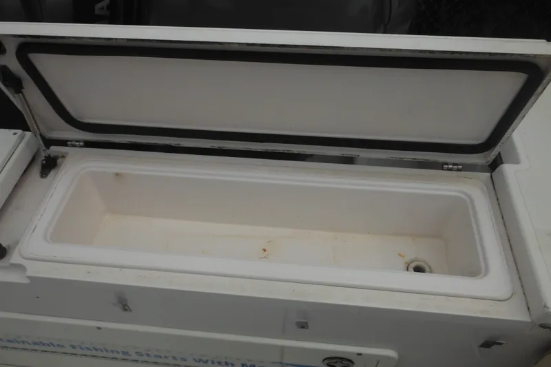 Slide: The Image of Open storage compartment on a 2006 Southport 26 Center Console boat. - 50