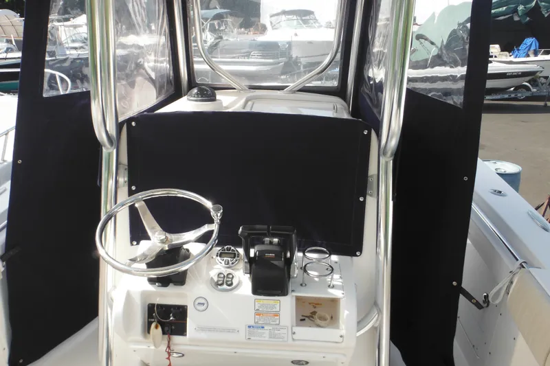 Slide: The Image of 2006 Southport 26 Center Console boat helm with steering wheel and controls. - 80