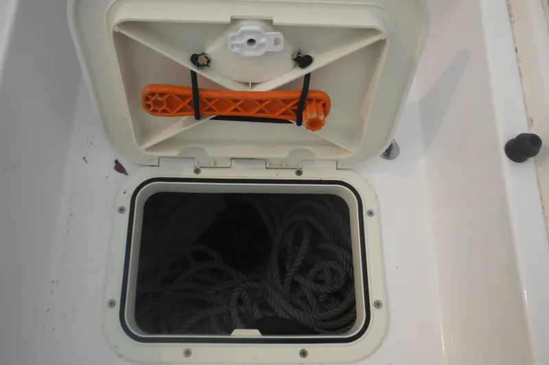 Slide: The Image of Open storage compartment on 2006 Southport 26 Center Console boat with coiled rope inside. - 19