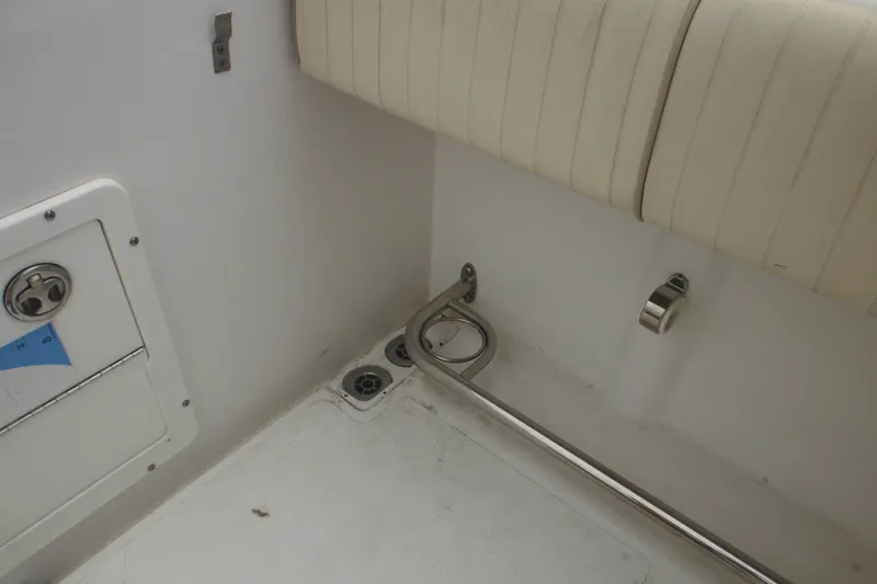 Slide: The Image of Interior view of a 2006 Southport 26 Center Console boat, featuring seating and storage. - 48
