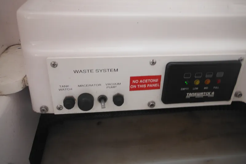 Slide: The Image of Control panel of 2006 Southport 26 Center Console waste system with Tank Watch indicators. - 60