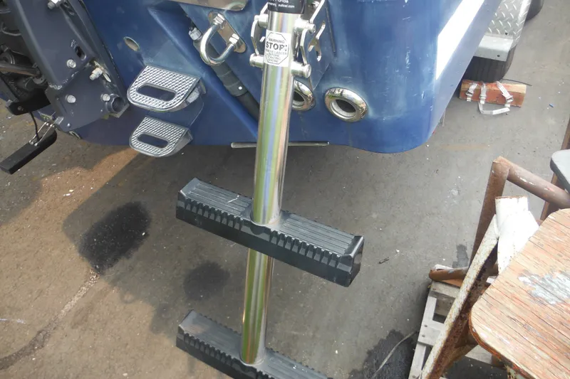 Slide: The Image of Rear view of a 2006 Southport 26 Center Console boat with a metal boarding ladder. - 14