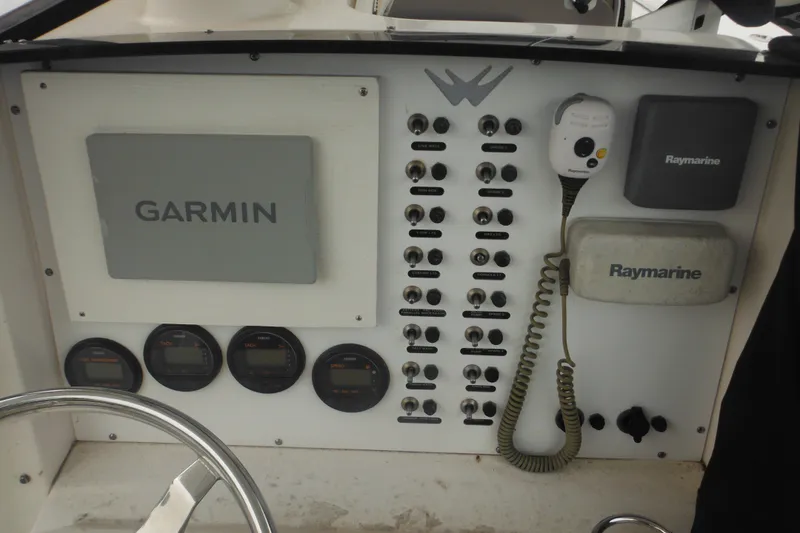 Slide: The Image of Control panel of a 2006 Southport 26 Center Console with Garmin and Raymarine equipment. - 39