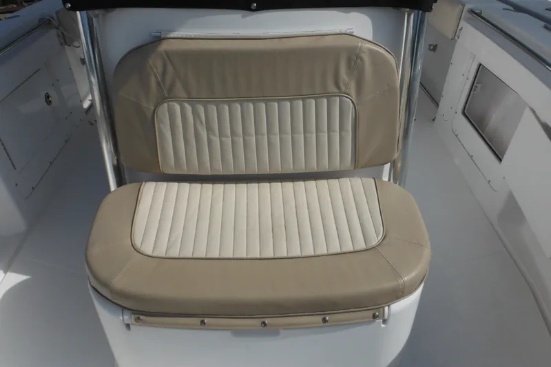 Slide: The Image of 2006 Southport 26 Center Console boat seat with beige and cream upholstery. - 68