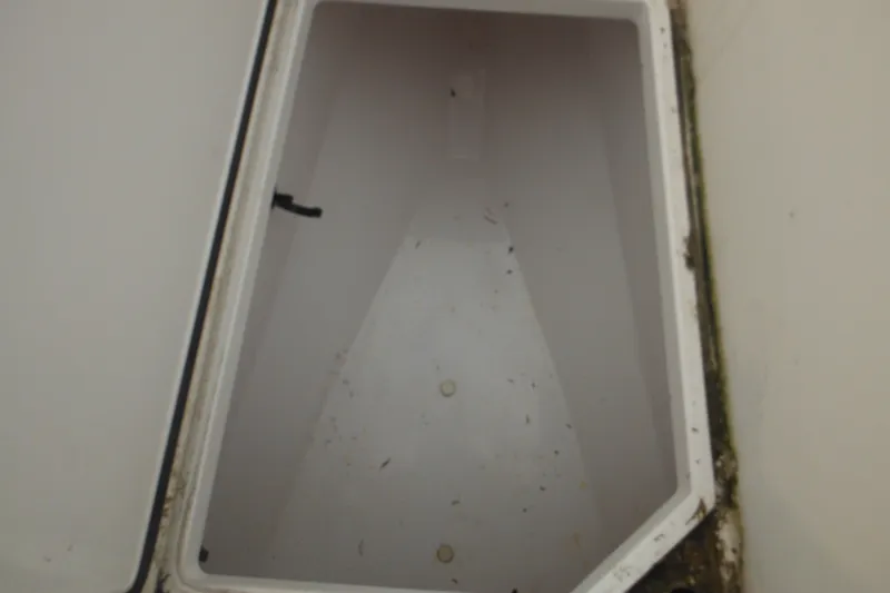 Slide: The Image of Open storage compartment on a 2006 Southport 26 Center Console boat. - 65