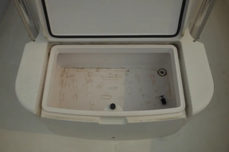 Slide: The Image of Open storage compartment on a 2006 Southport 26 Center Console boat. - 23