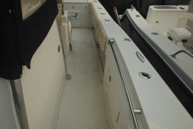 Slide: The Image of 2006 Southport 26 Center Console boat interior with seating and storage compartments. - 24