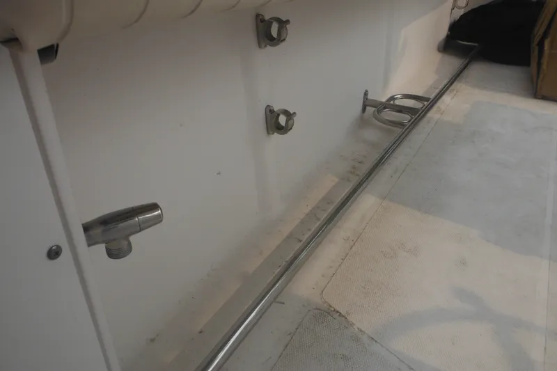 Slide: The Image of Interior view of a 2006 Southport 26 Center Console boat, featuring stainless steel fittings. - 27