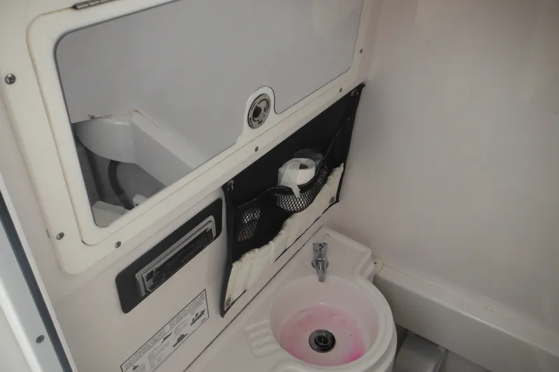 Slide: The Image of 2006 Southport 26 Center Console boat interior with sink and storage compartment. - 30