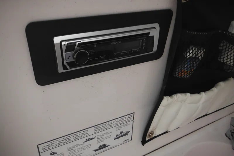 Slide: The Image of 2006 Southport 26 Center Console boat interior with Kenwood stereo system. - 31