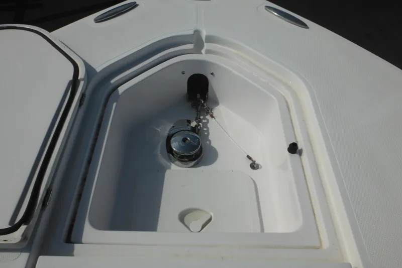 Slide: The Image of Anchor compartment of 2006 Southport 26 Center Console boat, featuring a clean, white design. - 71