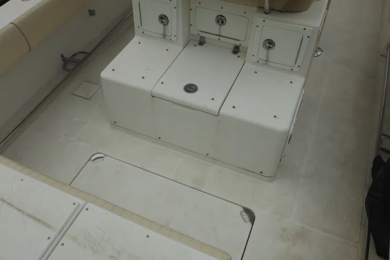 Slide: The Image of 2006 Southport 26 Center Console boat interior with seating and storage compartments. - 67
