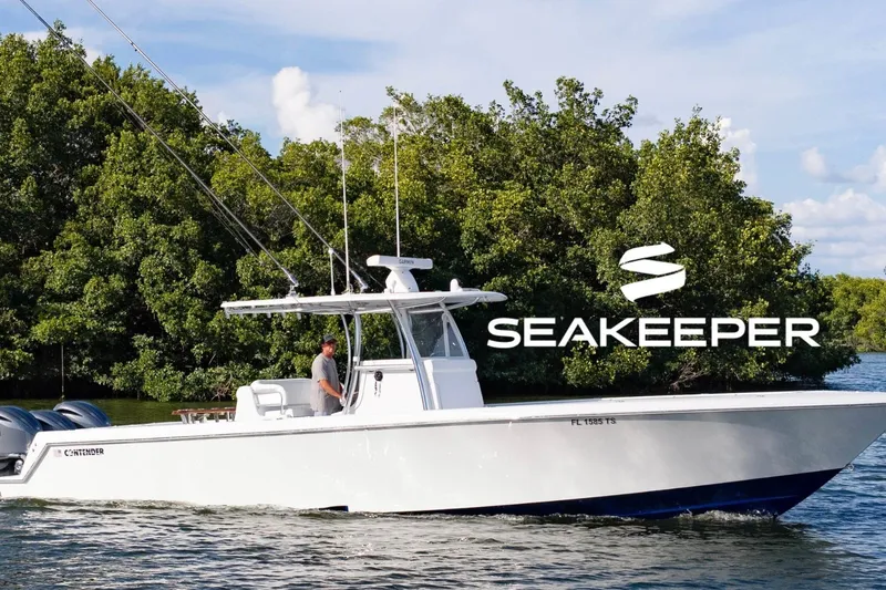 The Image of 2024 Contender 39 ST boat cruising near lush greenery, featuring Seakeeper stabilization. - 0