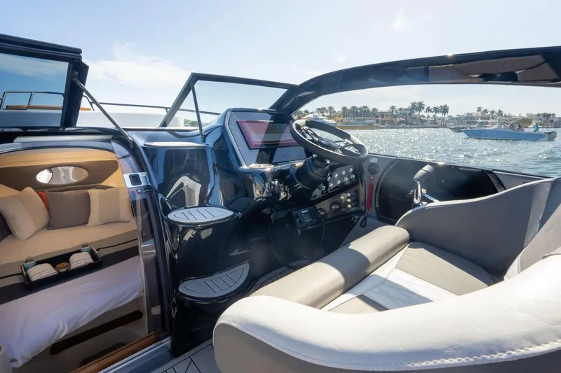 Slide: The Image of Interior view of 2026 Hanover 305 boat, featuring modern cockpit and cozy cabin. - 13