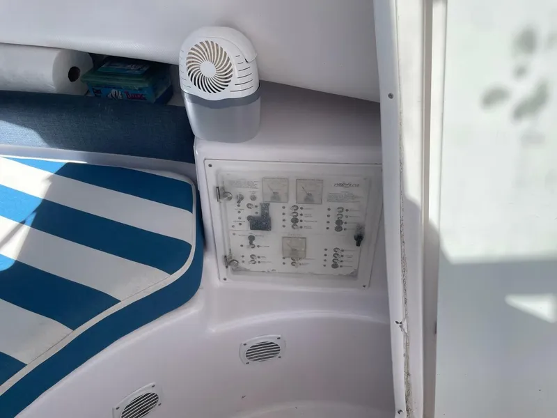 Slide: The Image of The image shows a boat interior with a blue striped seat and a control panel. - 23