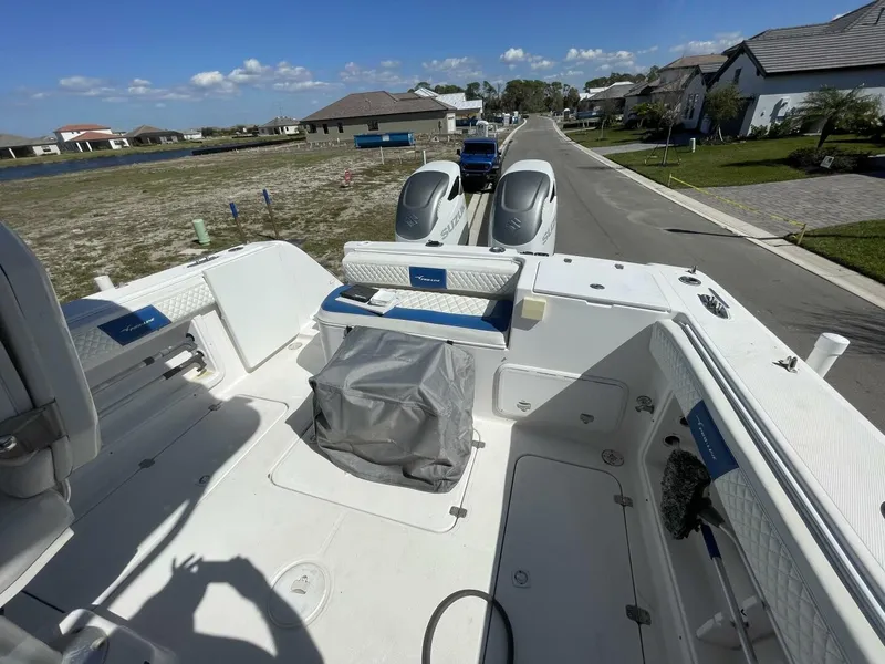 Slide: The Image of 2004 Pro-Line 30 Express Walkaround with twin outboard engines, on a trailer in a residential area. - 36