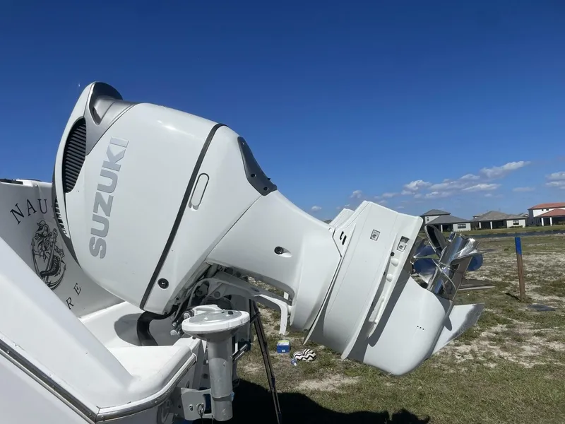 Slide: The Image of A Suzuki outboard motor on a 2004 Pro-Line 30 Express Walkaround boat. - 16