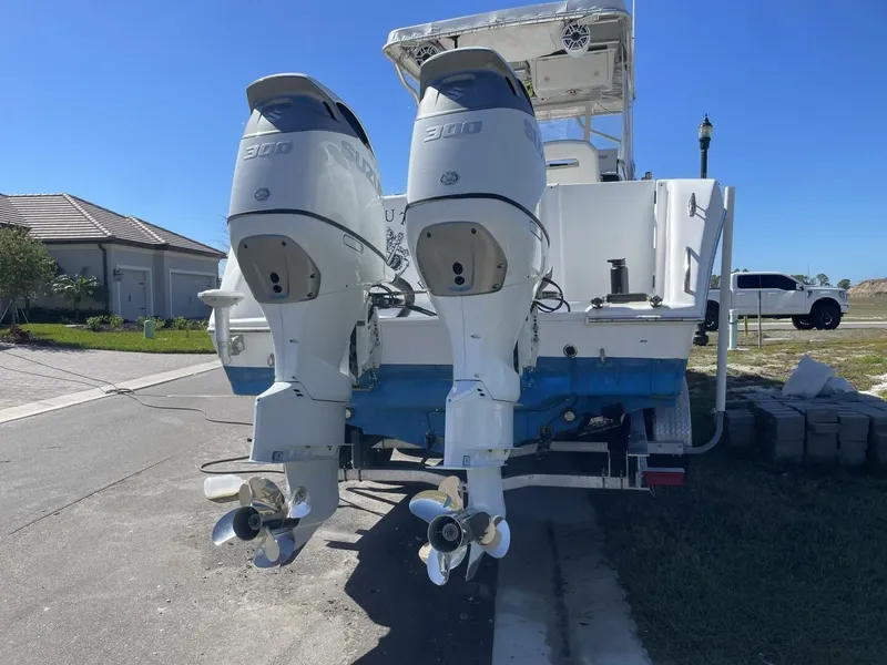 Slide: The Image of Two powerful outboard engines are mounted on the stern of a 2004 Pro-Line 30 Express Walkaround boat. - 31