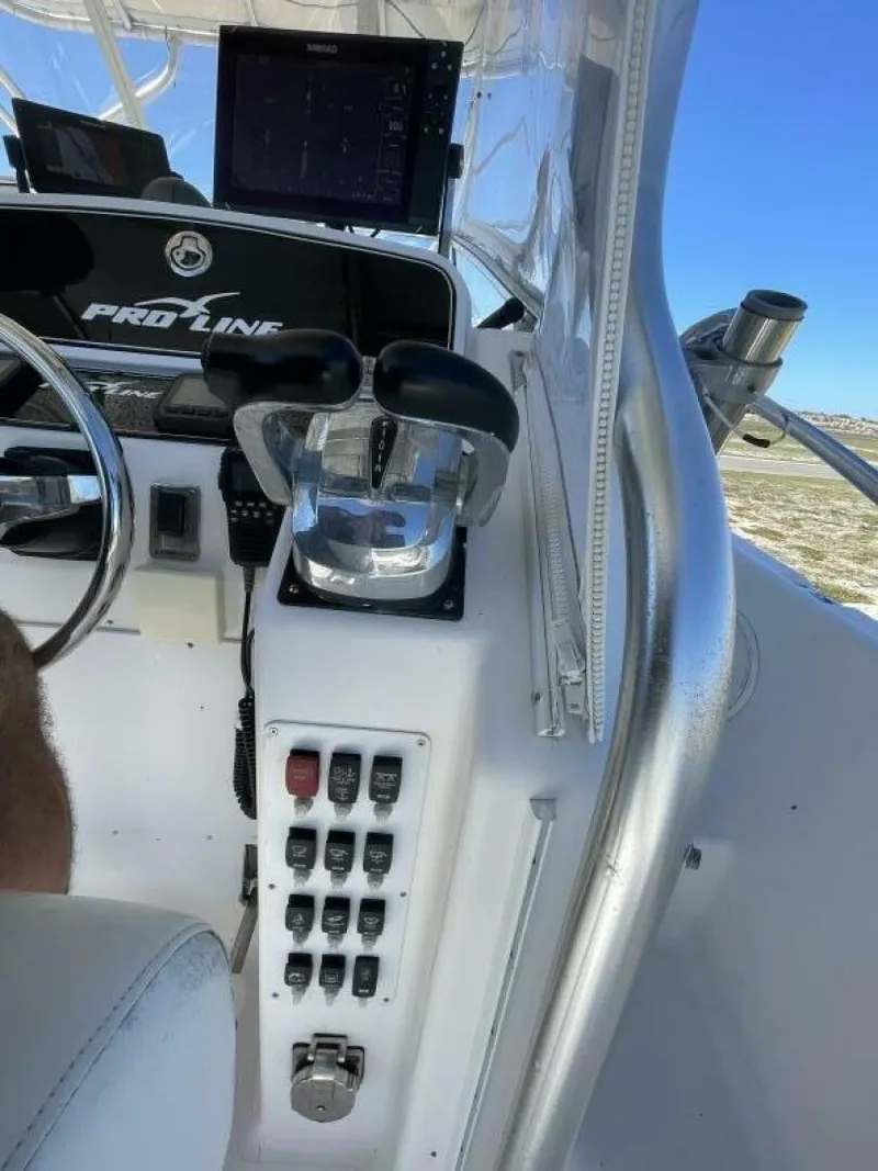 Slide: The Image of The image shows the helm of a 2004 Pro-Line 30 Express Walkaround with throttle controls and instruments. - 34
