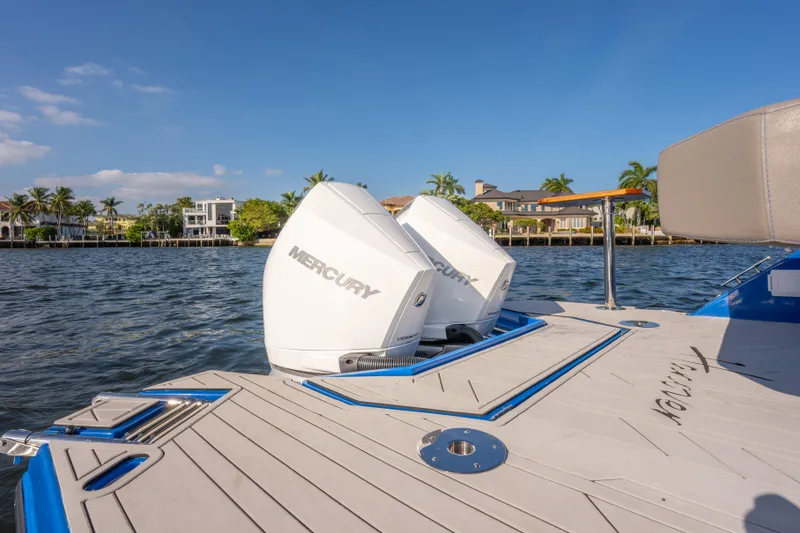 Slide: The Image of 2026 Hanover 347 boat with dual Mercury outboard engines on a sunny waterfront. - 14