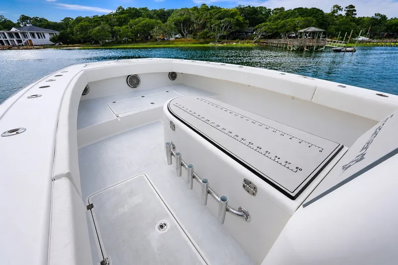 Slide: The Image of Spacious deck of 2014 Freeman 37 boat with rod holders and scenic waterfront view. - 11