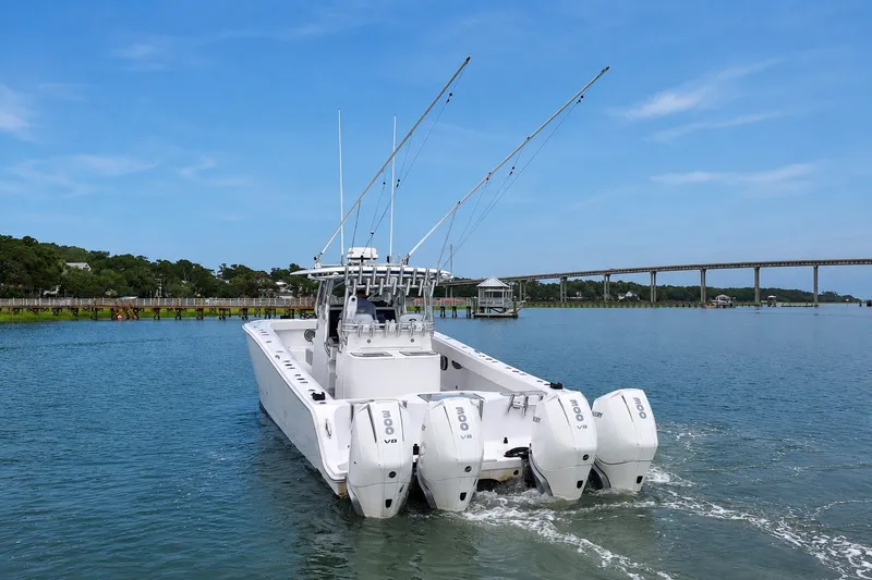 Slide: The Image of Freeman 37 boat from 2014 with four engines on a calm waterway. - 6