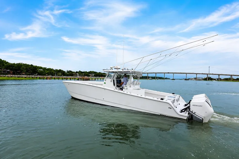 Slide: The Image of 2014 Freeman 37 boat cruising on a calm river under a clear blue sky. - 3