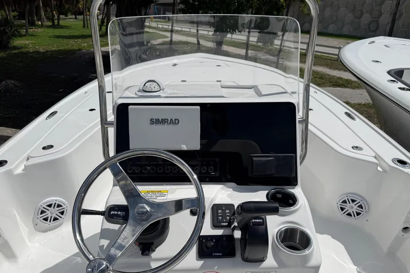 Slide: The Image of 2027 Tidewater 1910 Bay Max boat dashboard with steering wheel and Simrad display. - 5