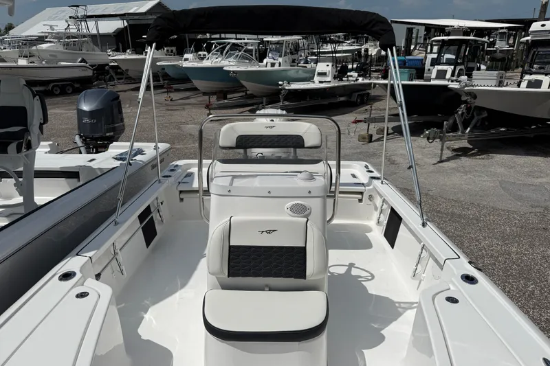 Slide: The Image of 2027 Tidewater 1910 Bay Max boat interior with seating and console, docked at a marina. - 7