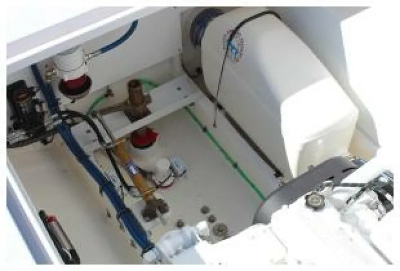 Slide: The Image of The engine compartment of a 2019 OceanPro 35 boat, showing engine and piping. - 8