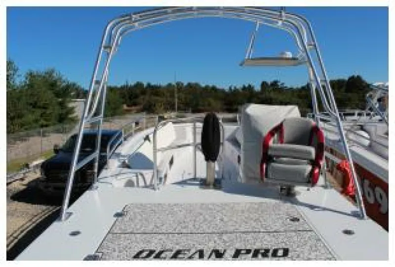 Slide: The Image of The image shows a 2019 OceanPro 35 boat with an open deck and a helm station. - 7