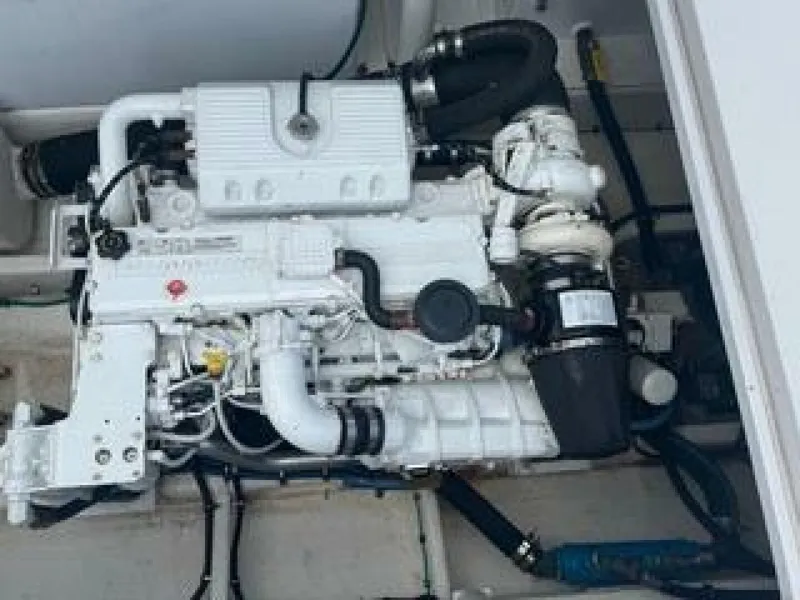 Slide: The Image of A clean, white engine in a boat's engine compartment, with various hoses and connections. - 5