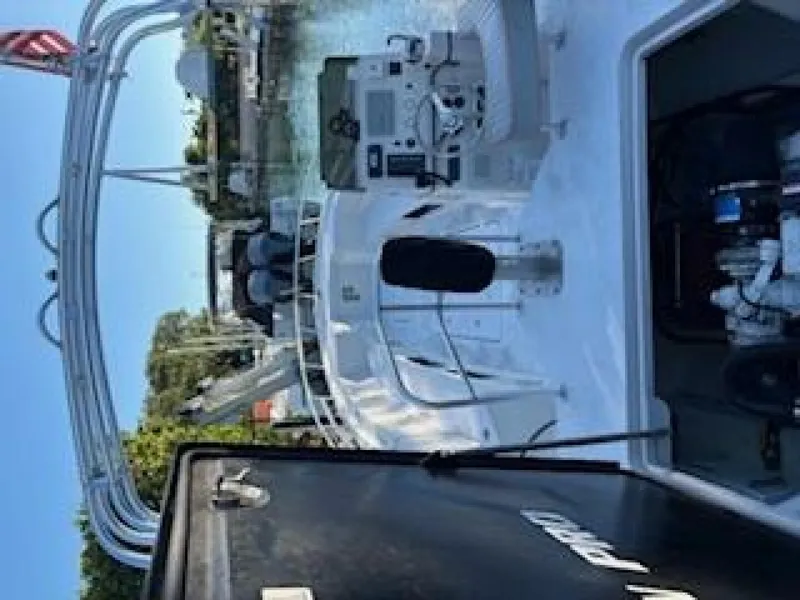 Slide: The Image of A 2019 OceanPro 35 boat with an open cockpit and helm, situated on calm waters. - 14