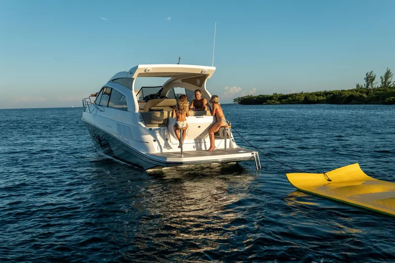 Slide: The Image of 2026 Hanover 375 yacht with people enjoying a sunny day on the water. - 63