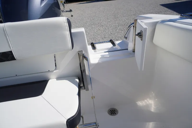 Slide: The Image of 2023 Tidewater 220 CC Adventure boat interior with seating and access door. - 45