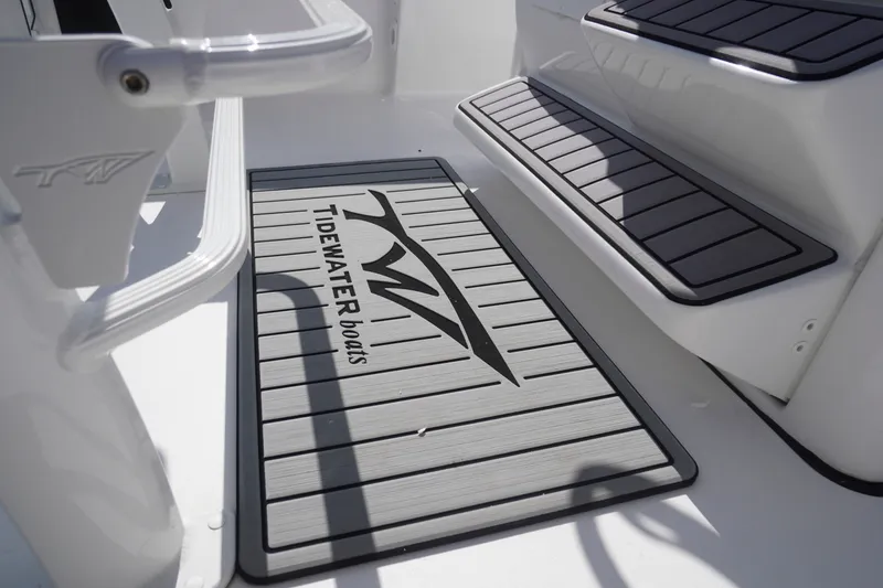 Slide: The Image of 2023 Tidewater 220 CC Adventure boat deck with branded non-slip mat and steps. - 27