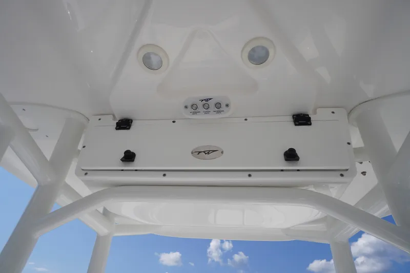 Slide: The Image of Tidewater 220 CC Adventure 2023 boat console with controls and storage compartment. - 31