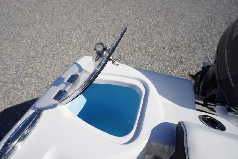 Slide: The Image of 2023 Tidewater 220 CC Adventure boat with open storage compartment and clear lid. - 39