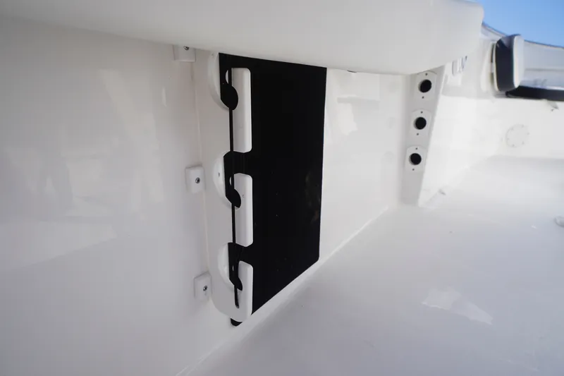 Slide: The Image of 2023 Tidewater 220 CC Adventure boat interior detail with rod holders and storage compartment. - 36